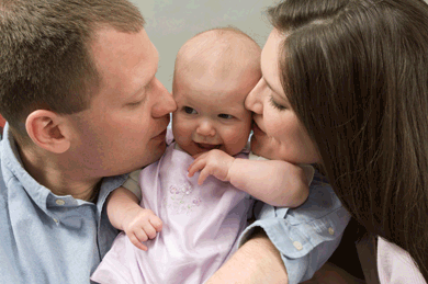 Loving father and mother with baby