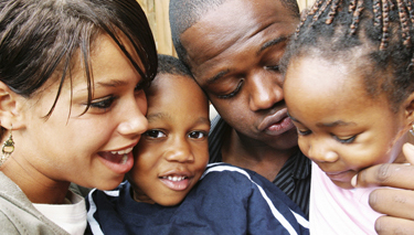 African mother, father, son and daughter smiling