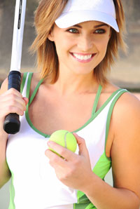 Smiling woman with tennis racquet